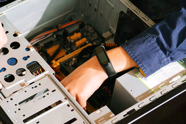 Hand inside computer chassis